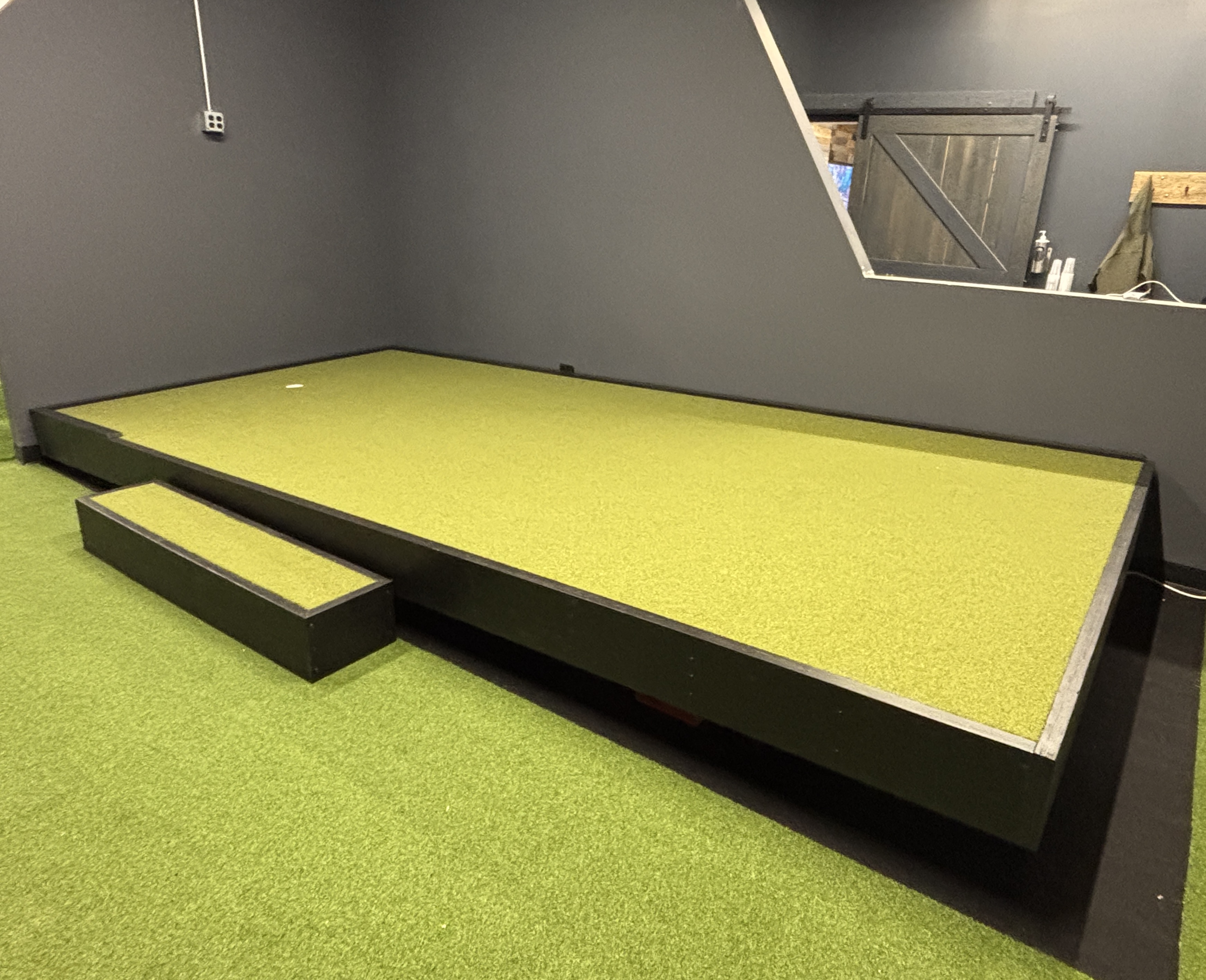 Made Golf putting deck at an angle showing dynamic tilting capability